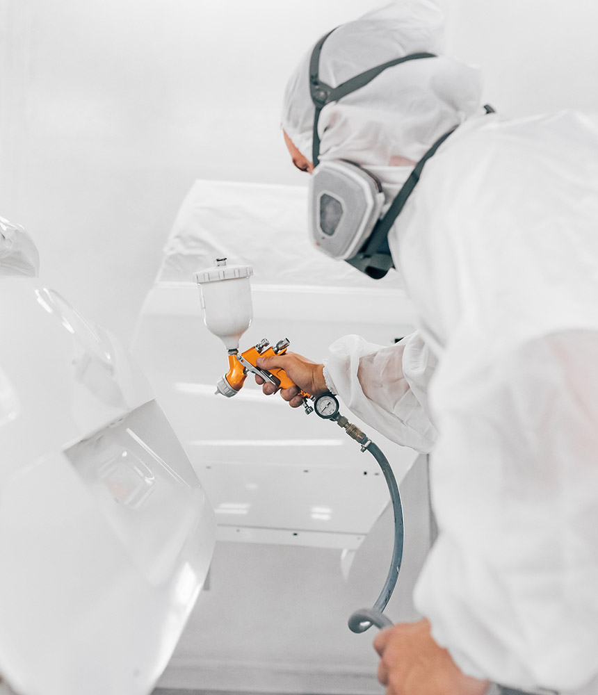 auto paint technician refinishing vehicle after auto body repair