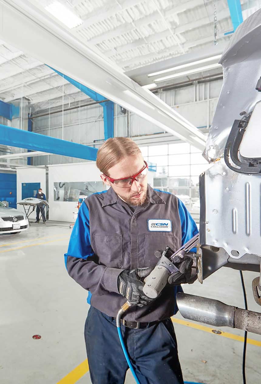 CSN Collision auto technician fixing car