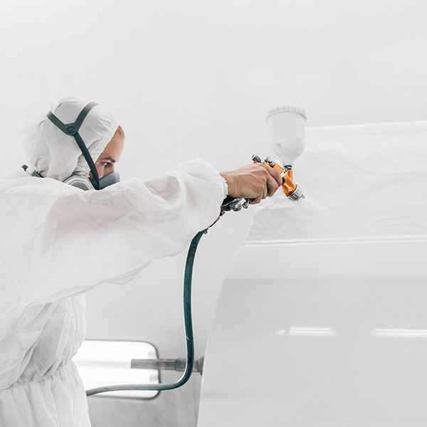 auto painter in spraybooth at Mills Collision Center